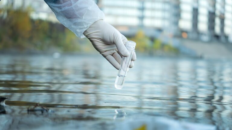 Person filling up test tube with water