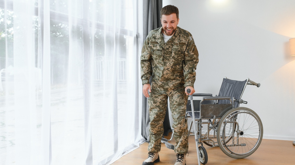Happy soldier in military uniform getting up from wheelchair