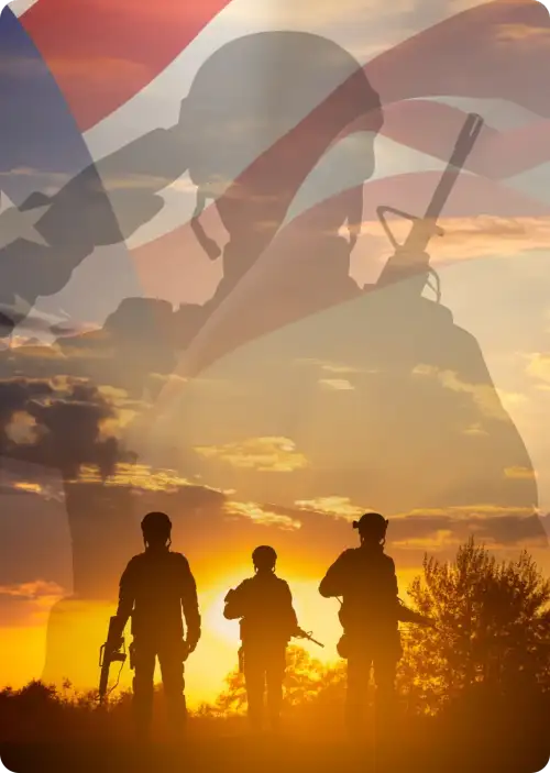 Silhouette of three soldiers saluting the American flag against a sunset backdrop, symbolizing honor and patriotism.